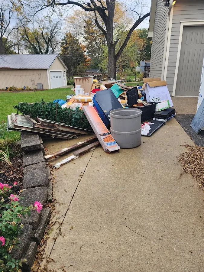 Dumpster being loaded with debris for Residential Dumpster Rental in Greendale